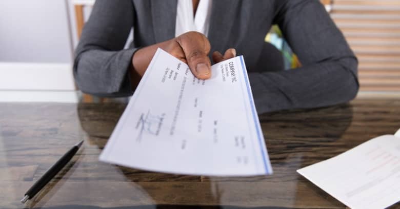 Woman handing over paycheck