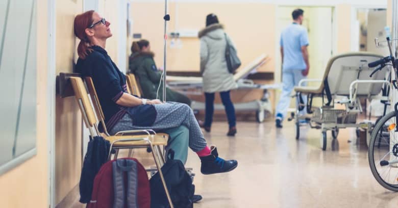 A woman sits in a hospital waiting room