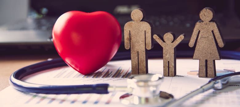 An image with cardboard cuts of a family of three searching for the best health insurance plan.