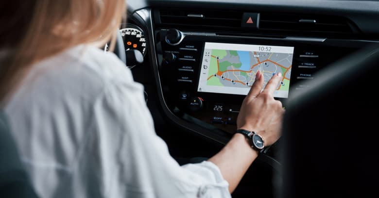 woman using navigation app inside a car