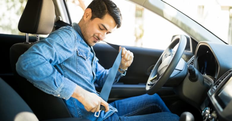 man fastening his seat belt