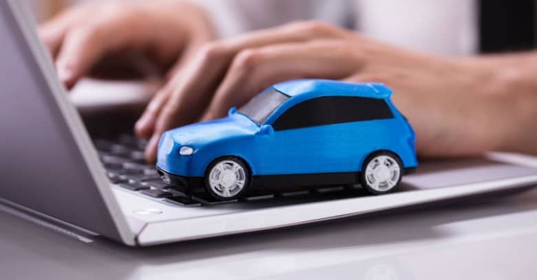 A small car on top of a laptop