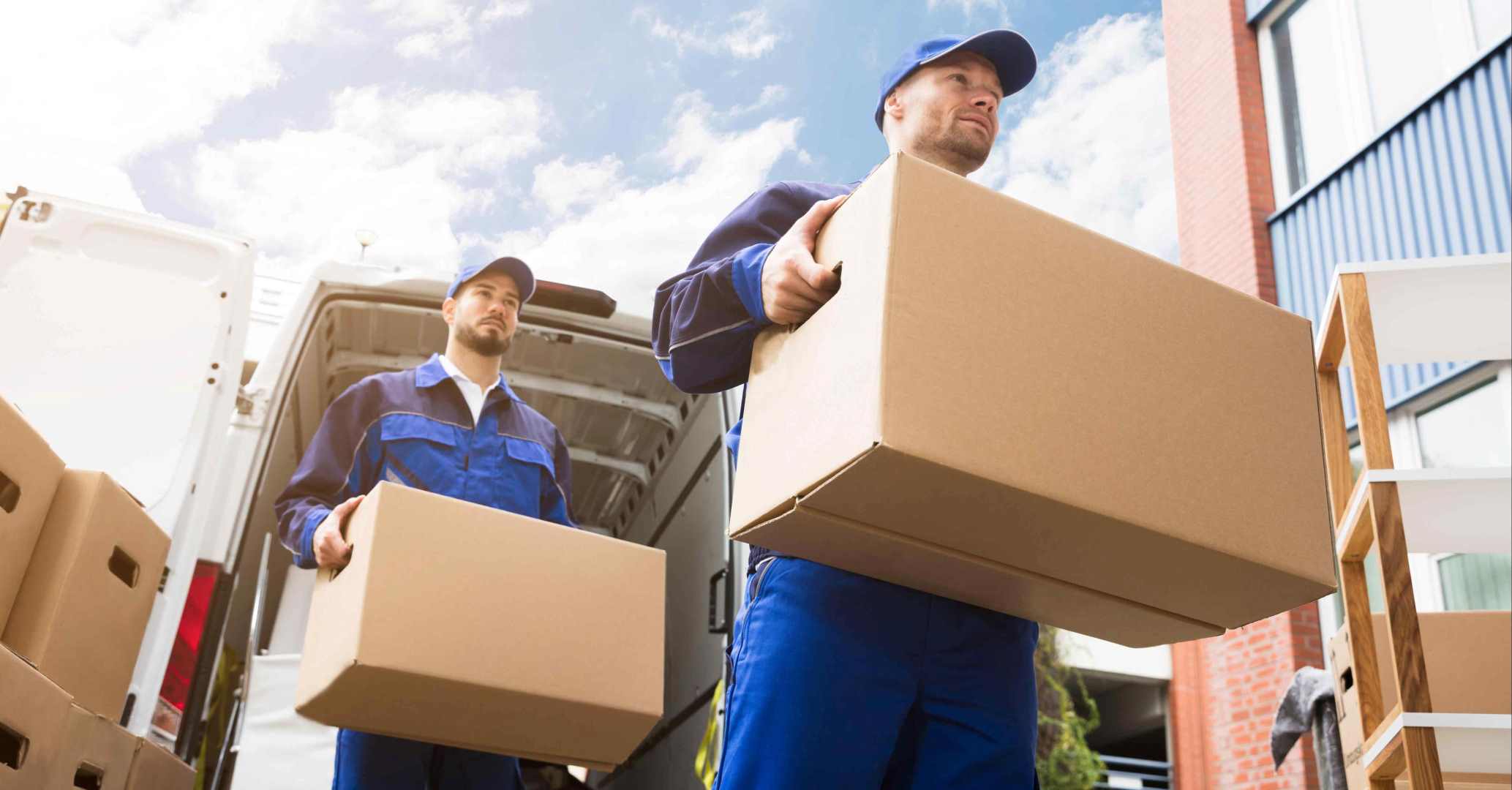 Two men moving boxes