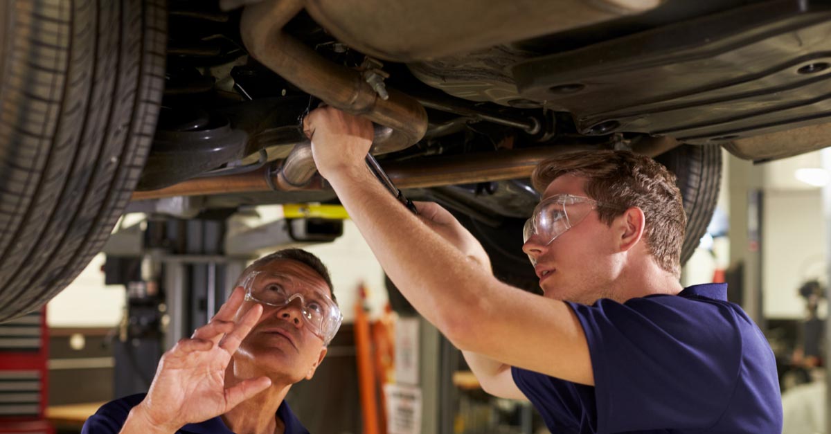 Students preforming car repairs