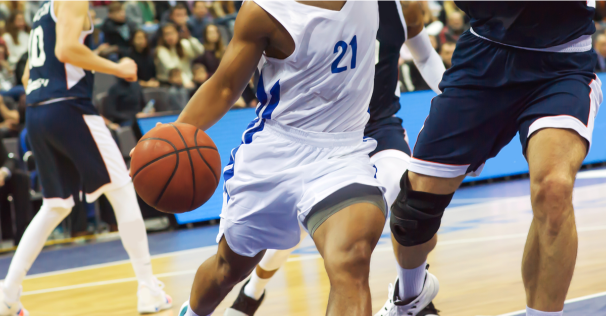 A professional basketball game is taking place on the court