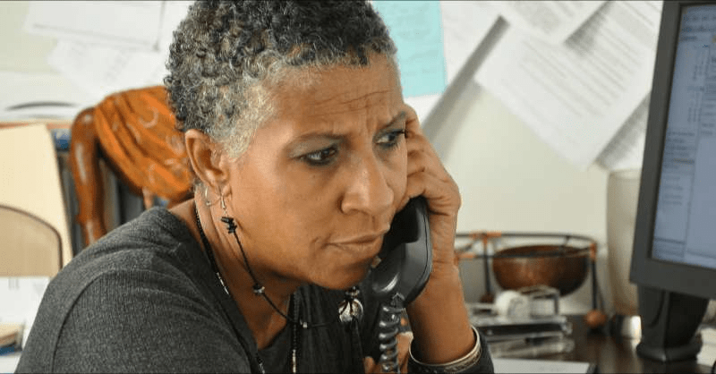 A business owner discusses paid time off options with one of her employees over the phone.