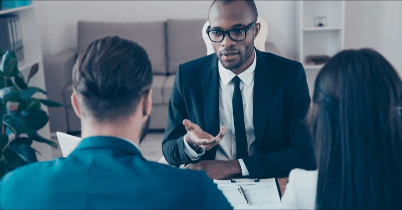 A bankruptcy lawyer meets with clients in his office.