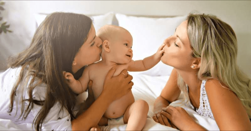 A lesbian couple enjoy time with their baby