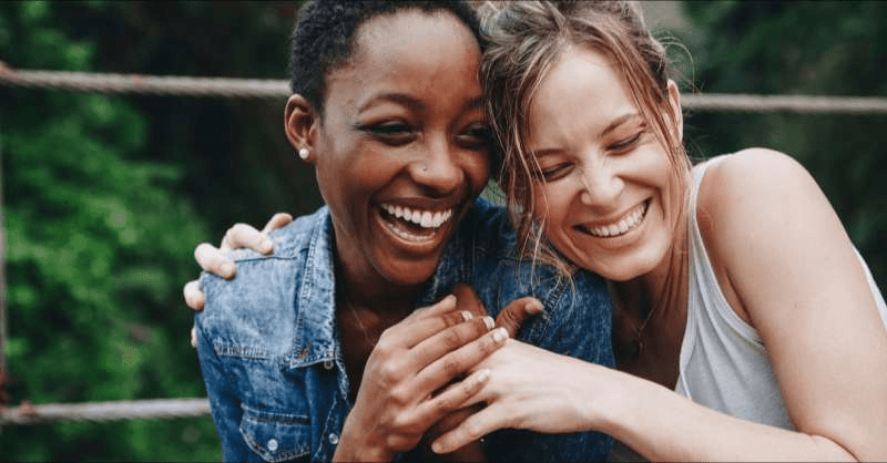 A lesbian couple spend time outside together