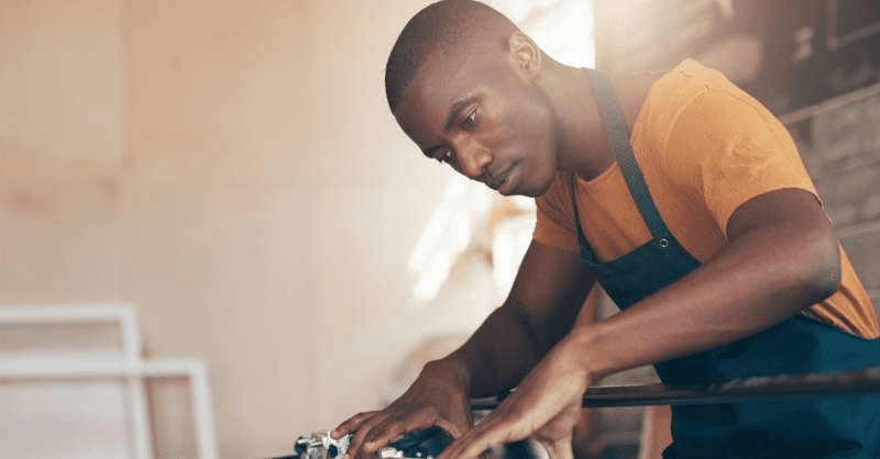 A business owner is seen creating a picture frame