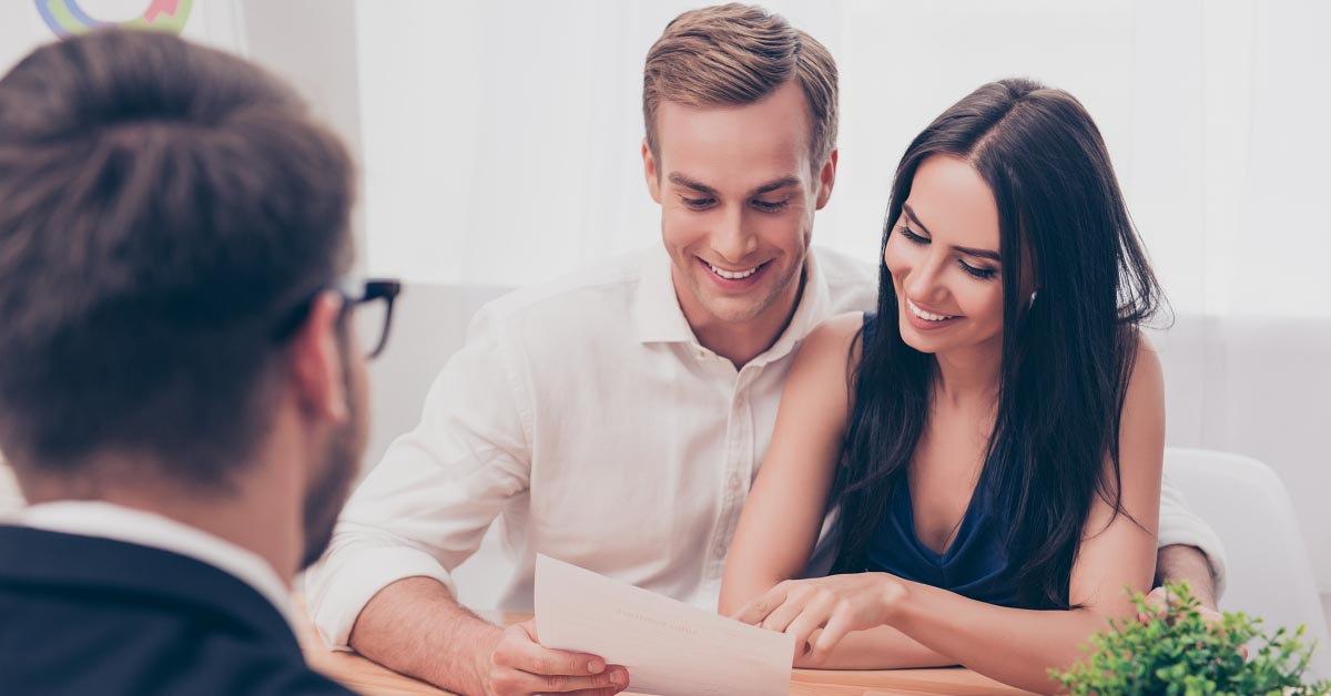 A couple examines a financial document.