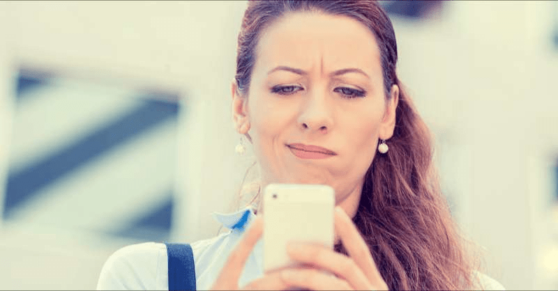 A woman tries to learn more about a charity but she looks skeptical as she ends a phone call.