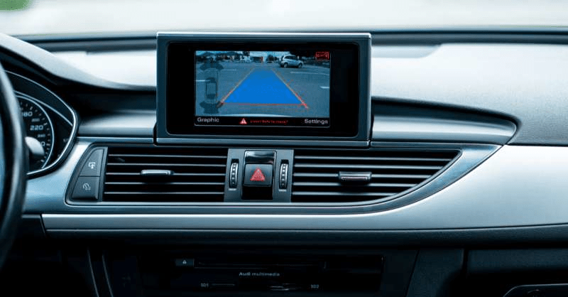 A backup camera is located on a car's dashboard area