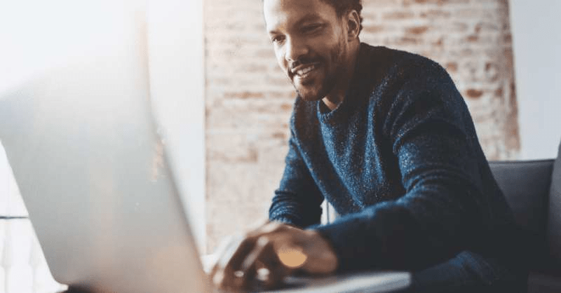 A man reviews the details of his car insurance via his laptop computer