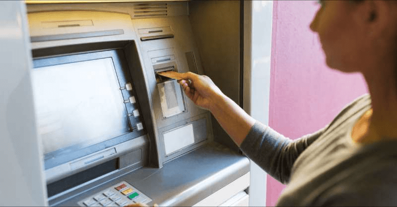 A woman uses an ATM for her banking needs