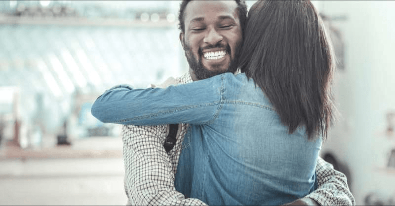 two people share a warm embrace