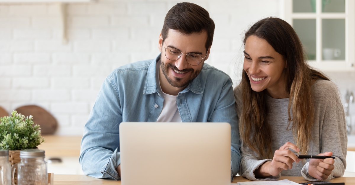 A couple reviews their savings account online