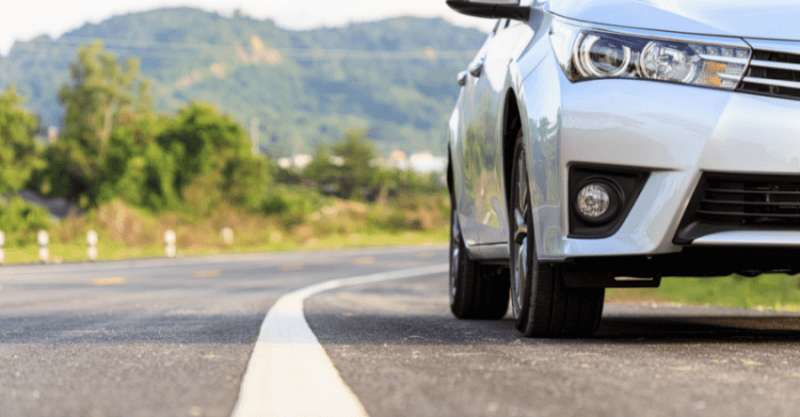 A car is seen driving on the road