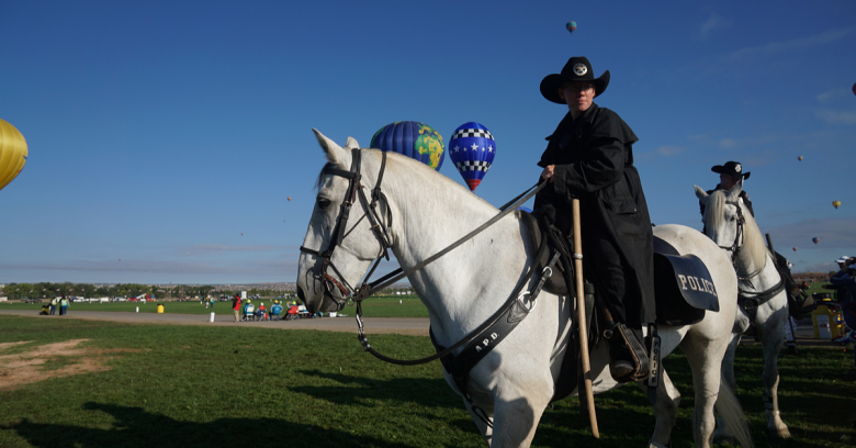 a law enforcement officer is on a horse during the Alburquerque, New Mexico Balloon Festival