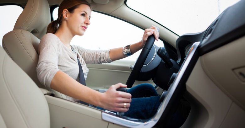 A confident woman drives her car.