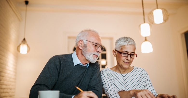 A middle-aged couple discusses how much car insurance they can afford.