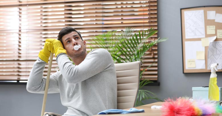 A lazy housecleaner is seen sitting down on the job and daydreaming