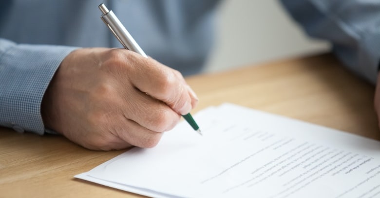 A man signs a legal document