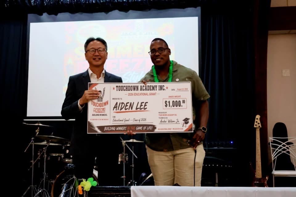 Founder Andre Wilson Jr. presenting grant award to scholarship recipient
