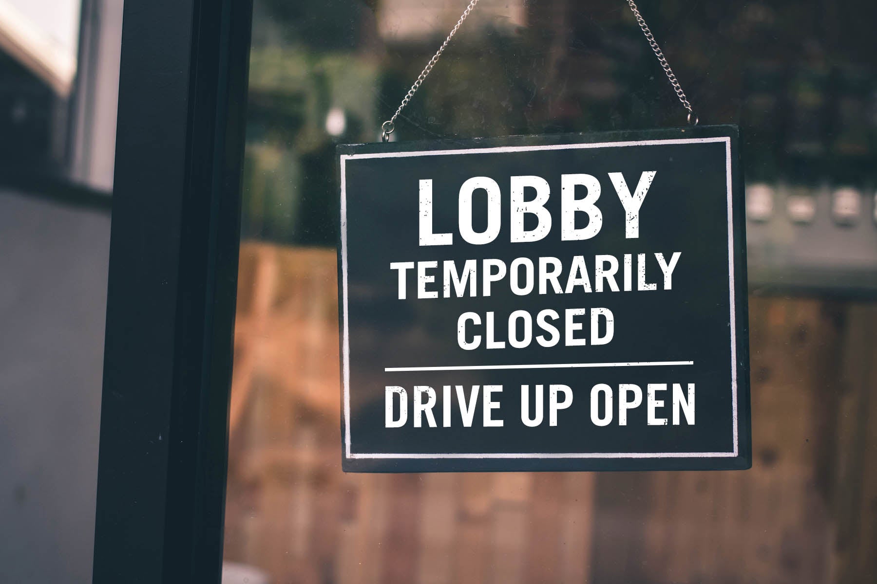 Front store Lobby temporarily closed sign while drive up open