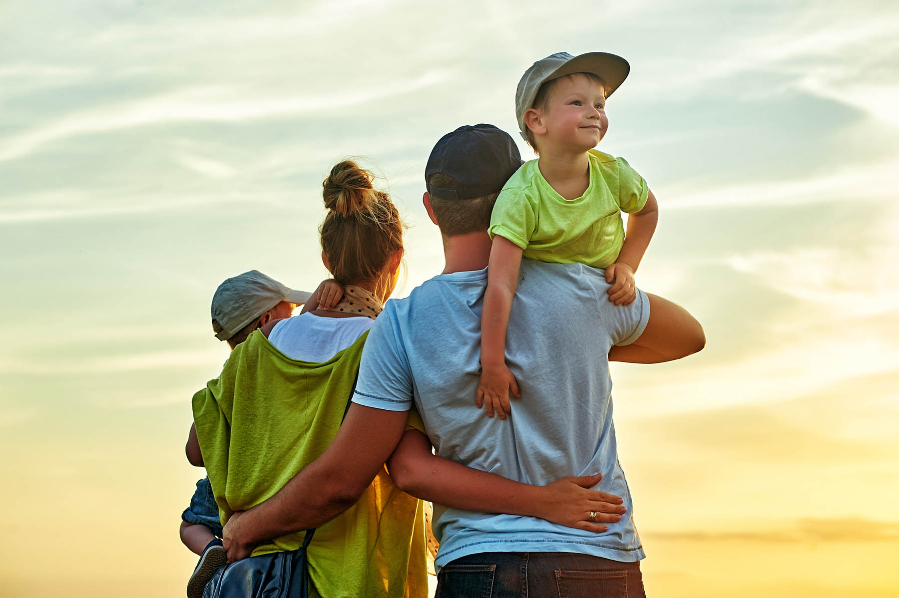 Family watching the sunset green and blue shirts