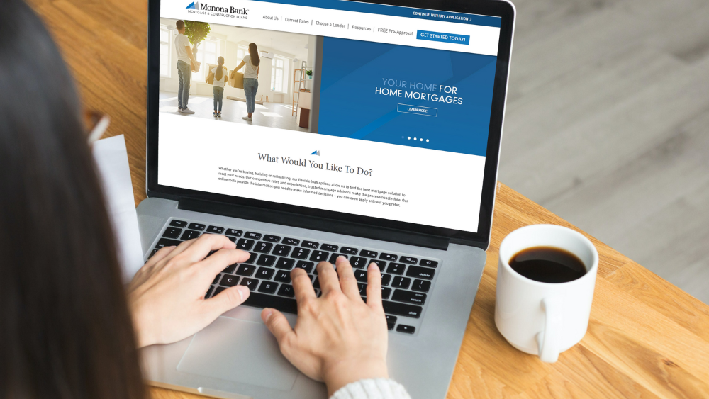 Woman browsing new Monona Bank Mortgage while having a cup of coffee.