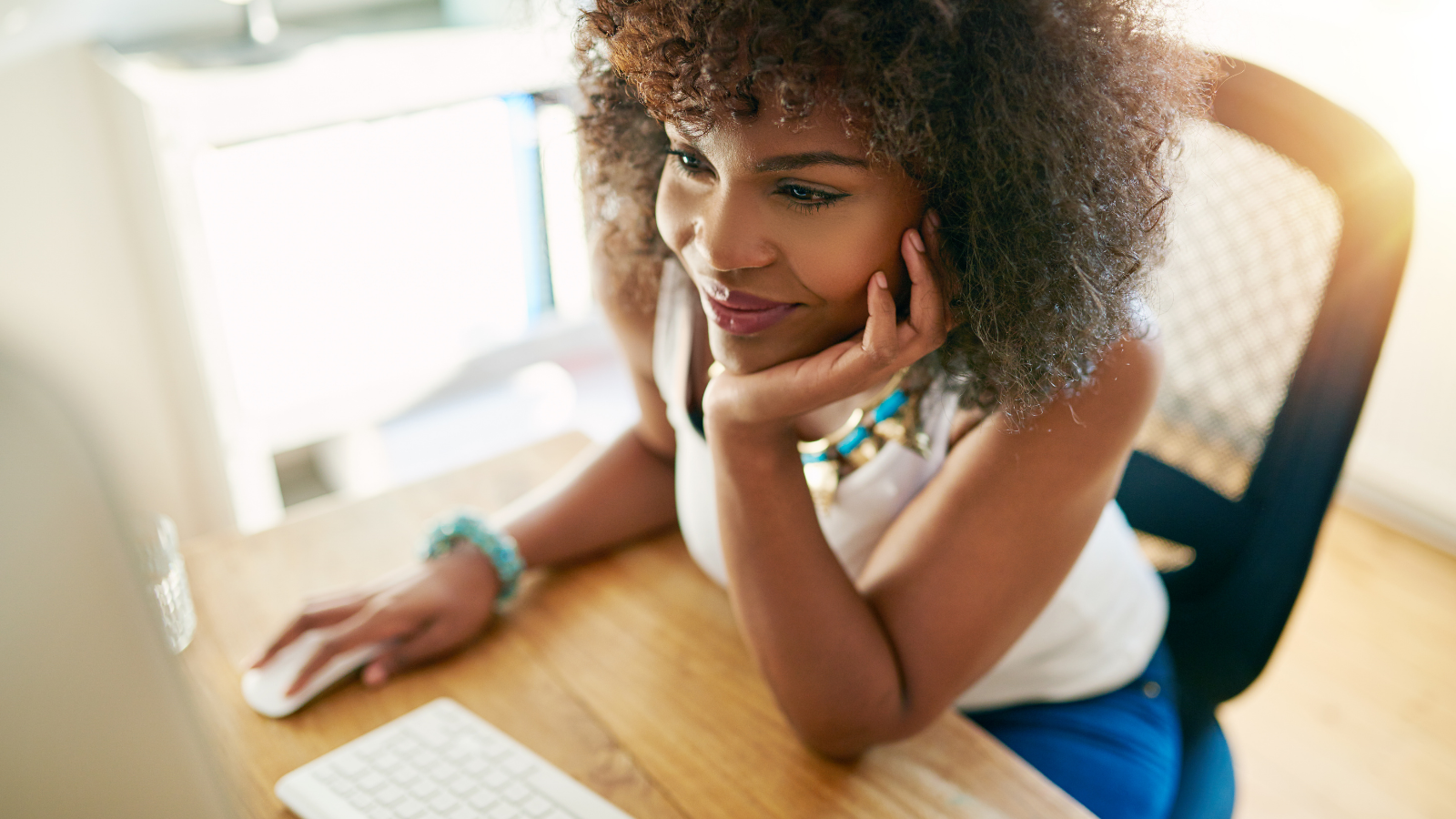 Woman working on her computer at her desk
