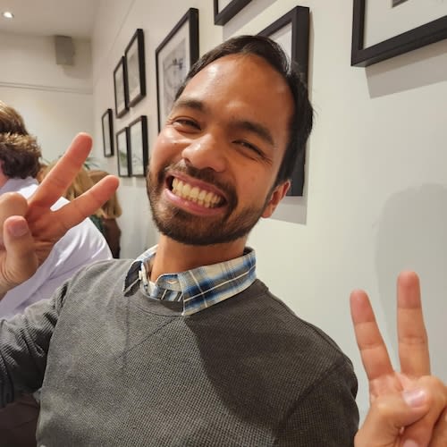 Me with peace sign fingers grinning at the camera