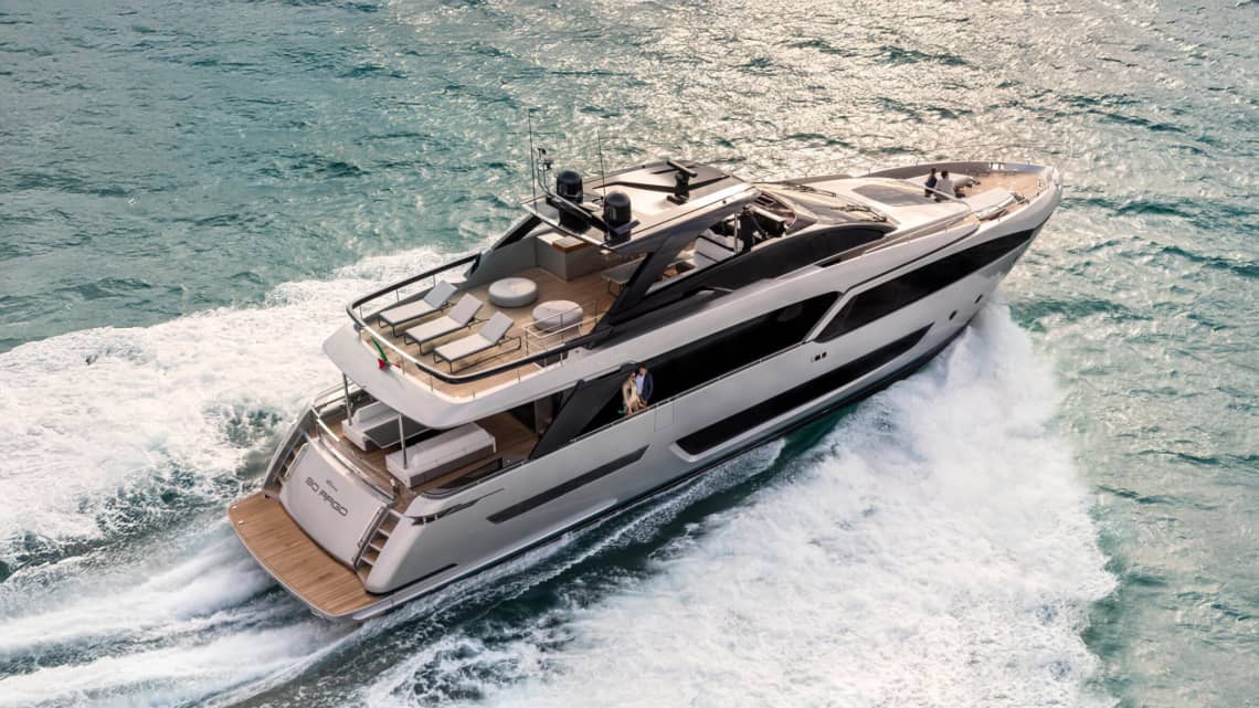 Yacht crusing through a light sea with a couple watching the view