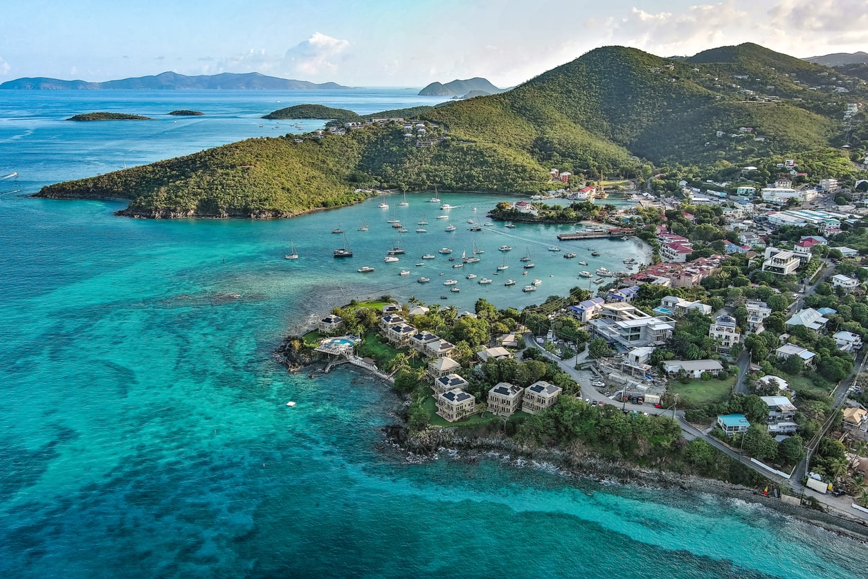 An aerial image above Cruz Bay on the issland of St. John, located in the US Virgin Islands. The British Virgin Islands can be seen in the background. Image captured during sunrise.