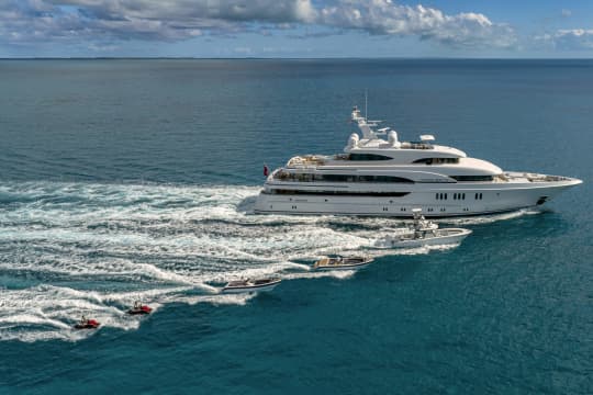 Marguerite Yacht sailing on the ocean with smaller boats next to it