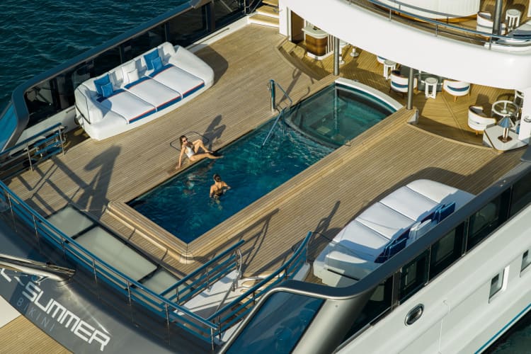 2 women in a pool on that is on the deck of a yacht