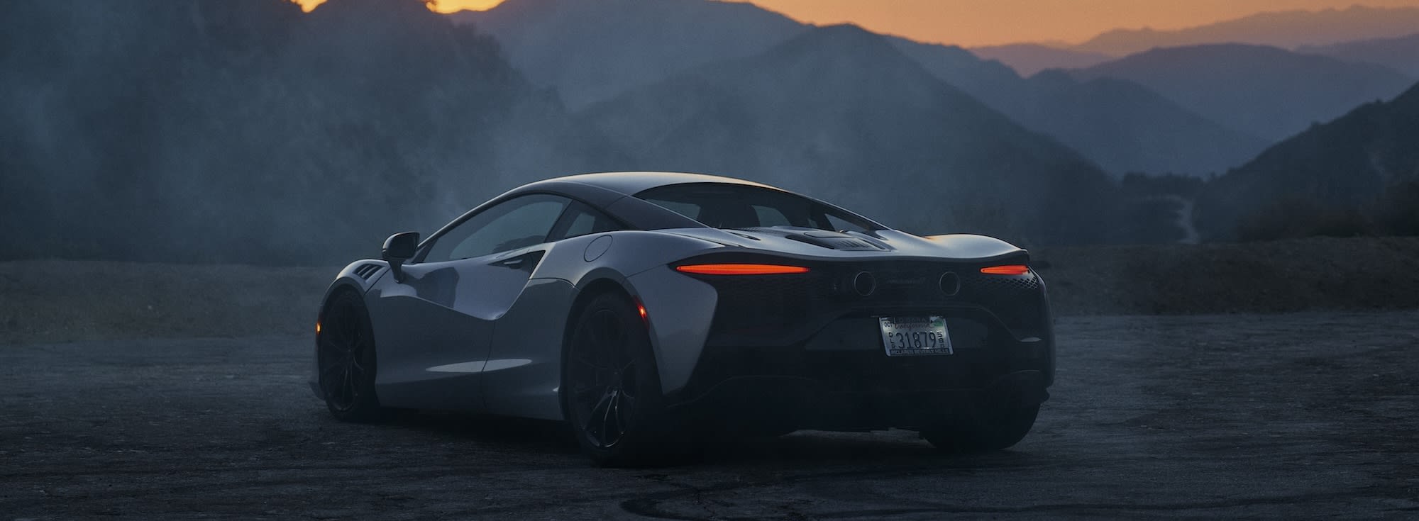 McLaren Artura on a canyon road at sunset