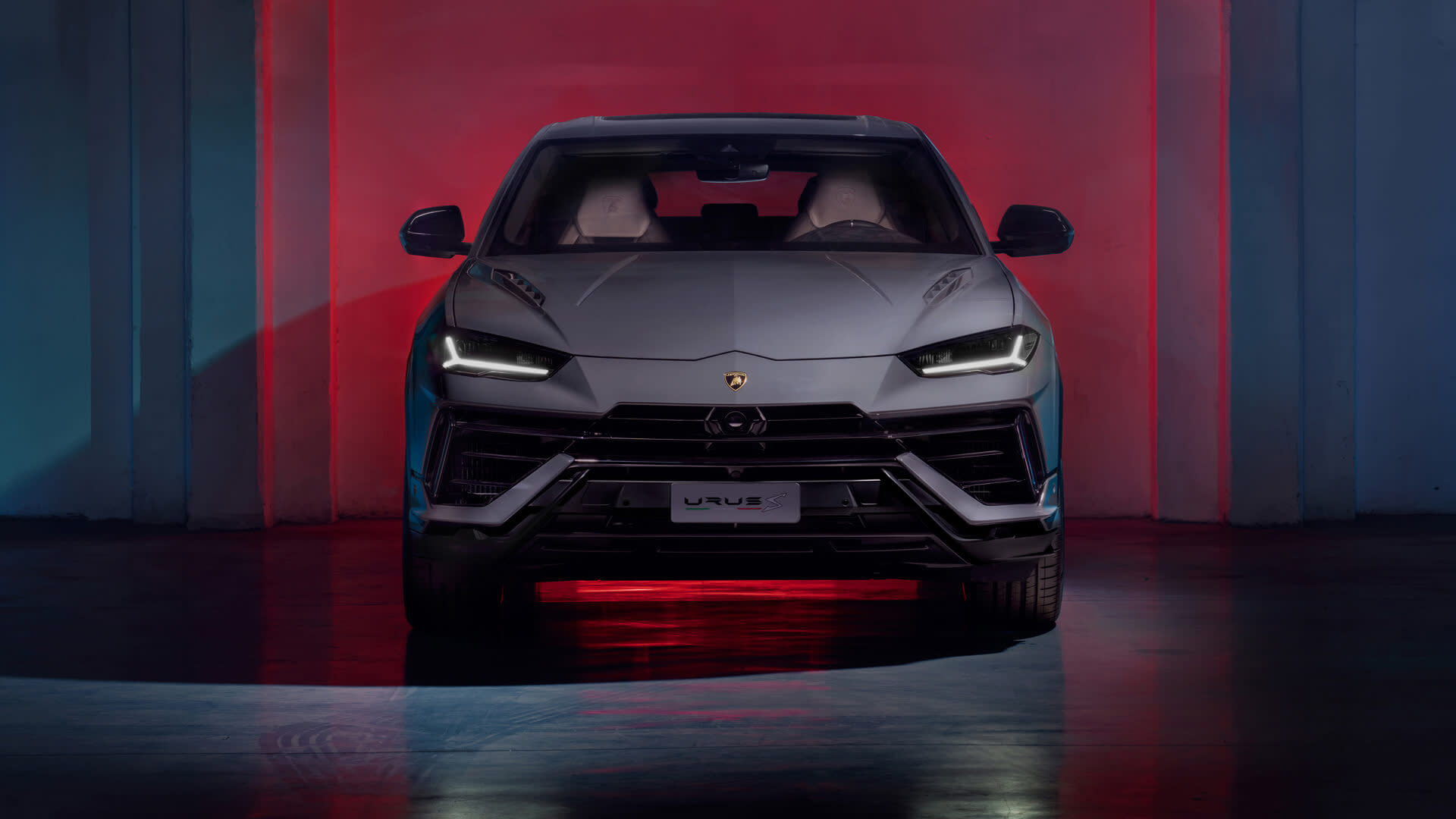 Lamborghini Urus S driving at speed on a mountain road during golden hour