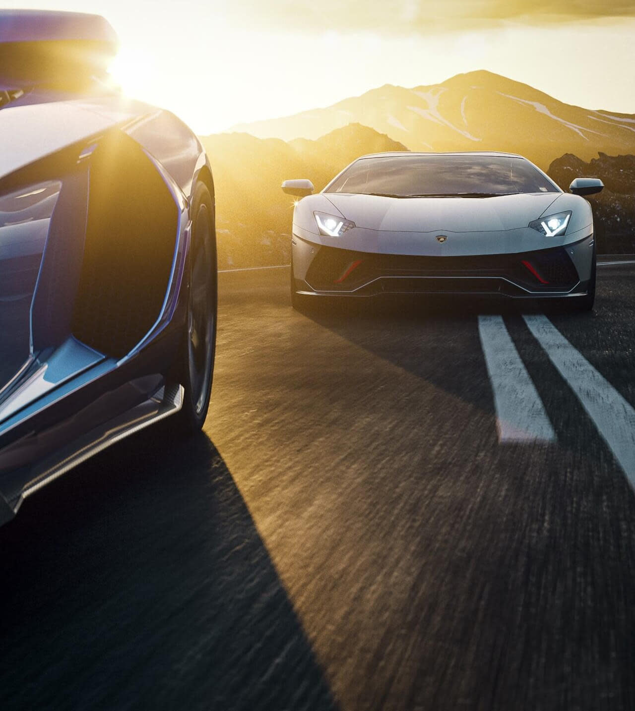The rear of an Lamborghini Aventador driving in a scenic landscape