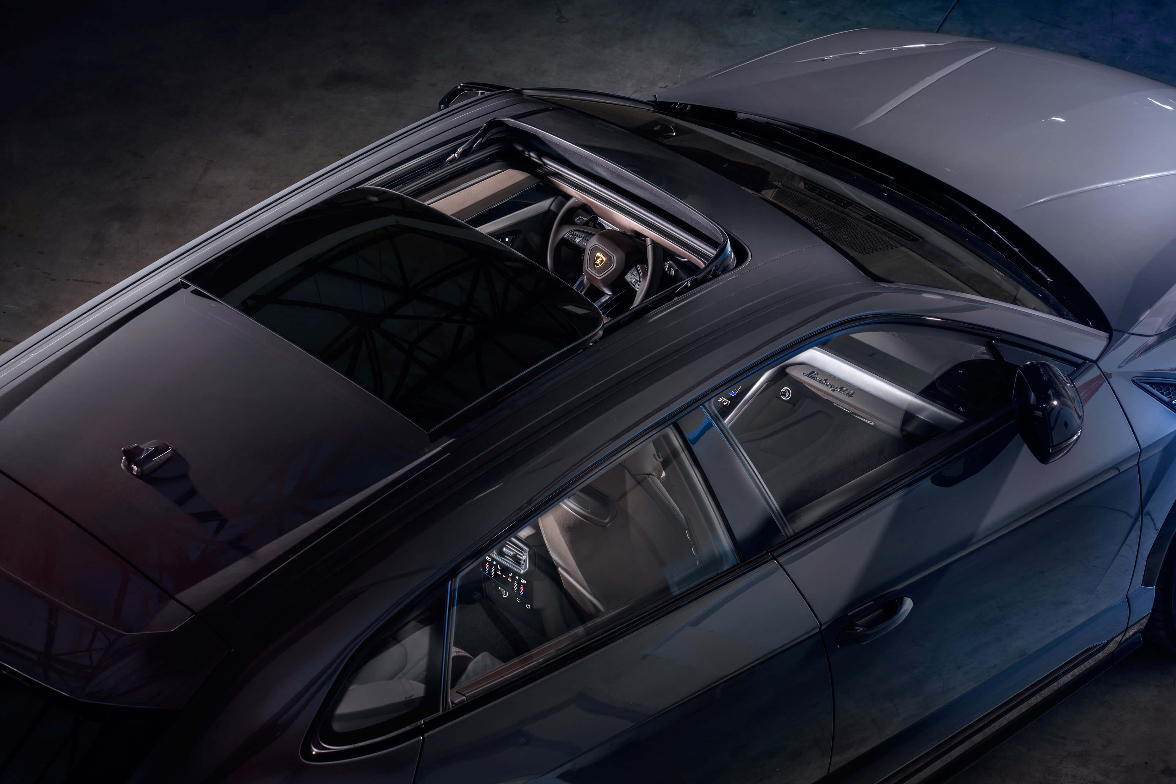 Lamborghini Urus S driving at speed on a mountain road during golden hour