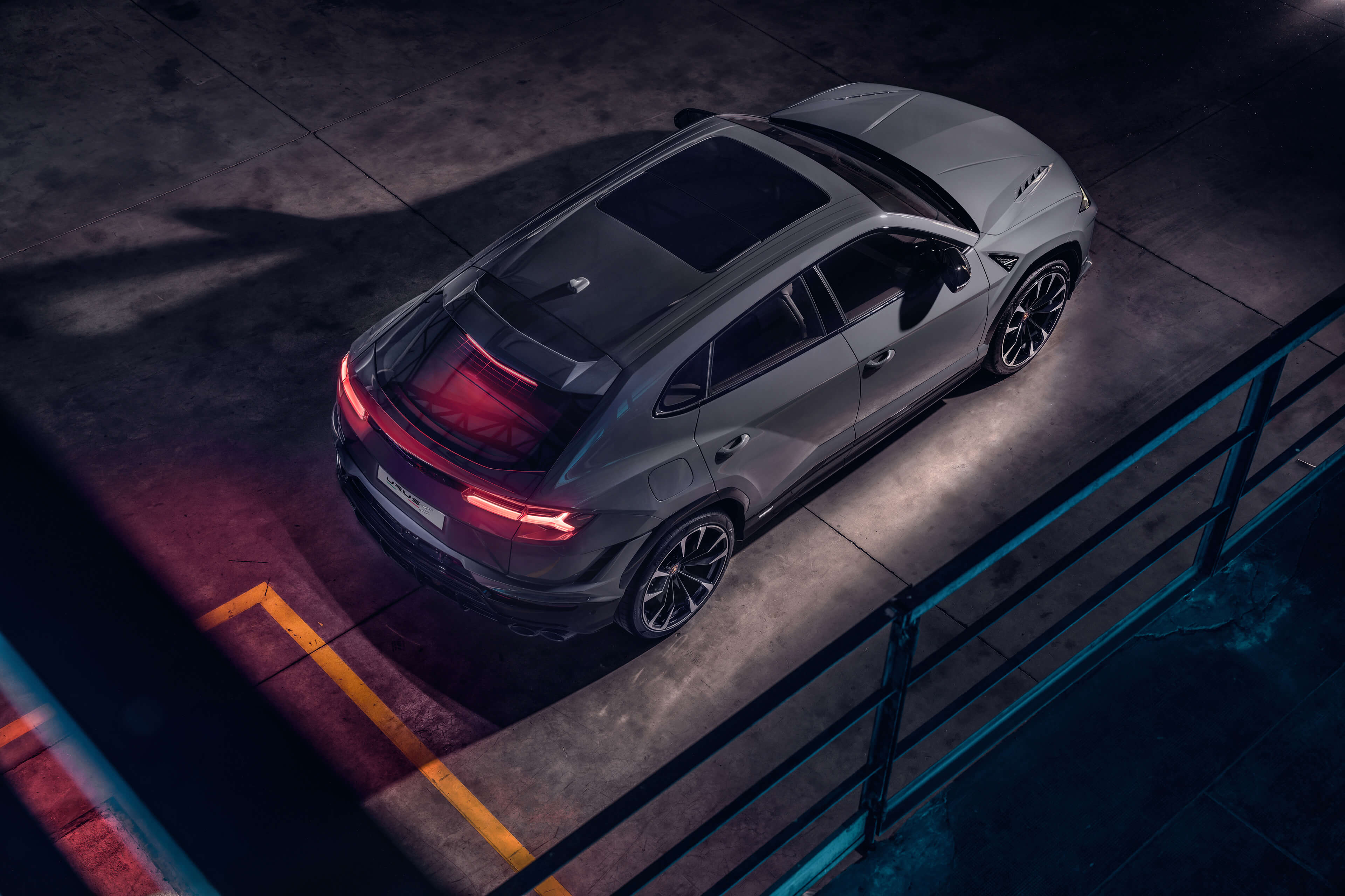 Lamborghini Urus S driving at speed on a mountain road during golden hour