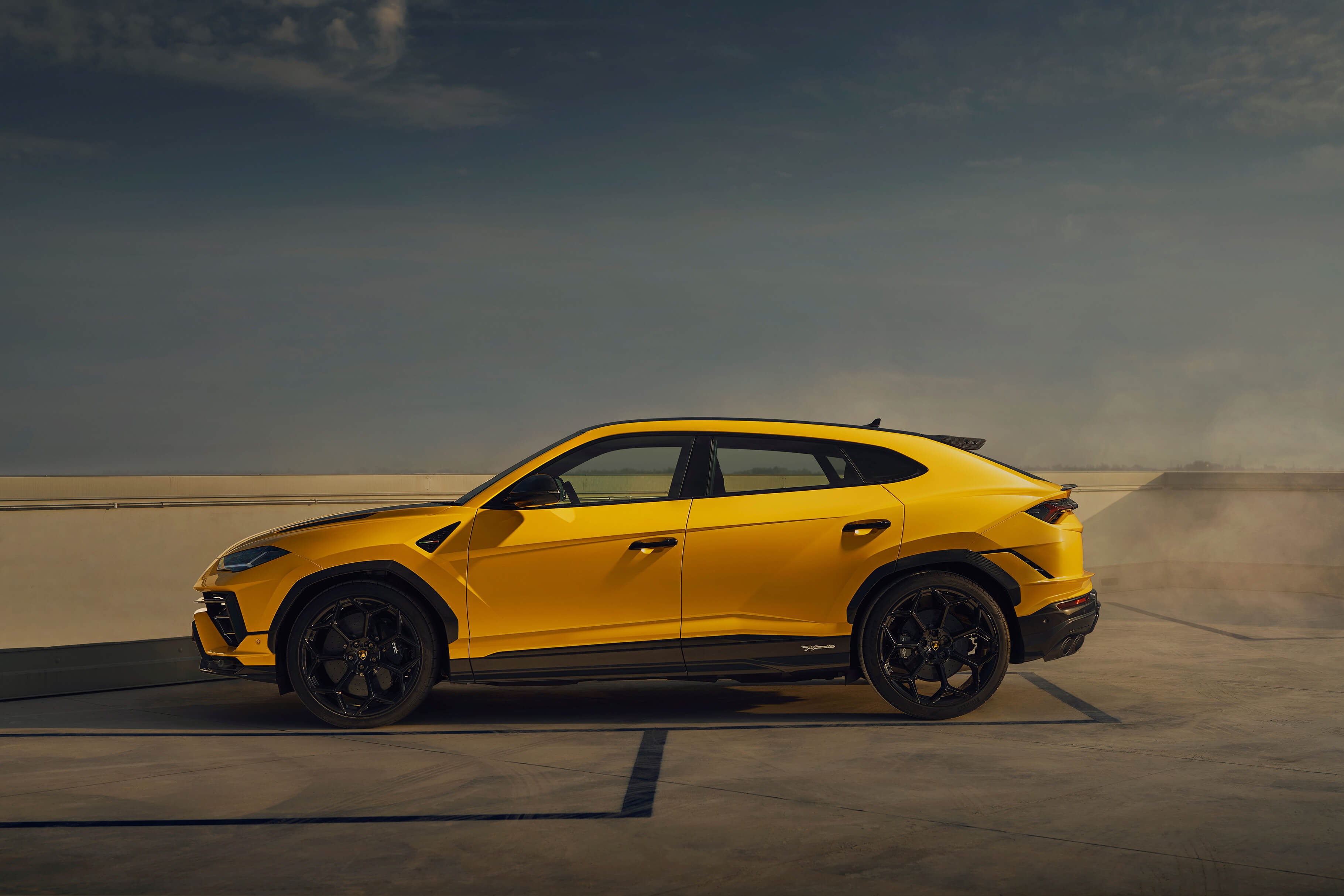 Lamborghini Urus Performante driving on a winding mountain road at high speed
