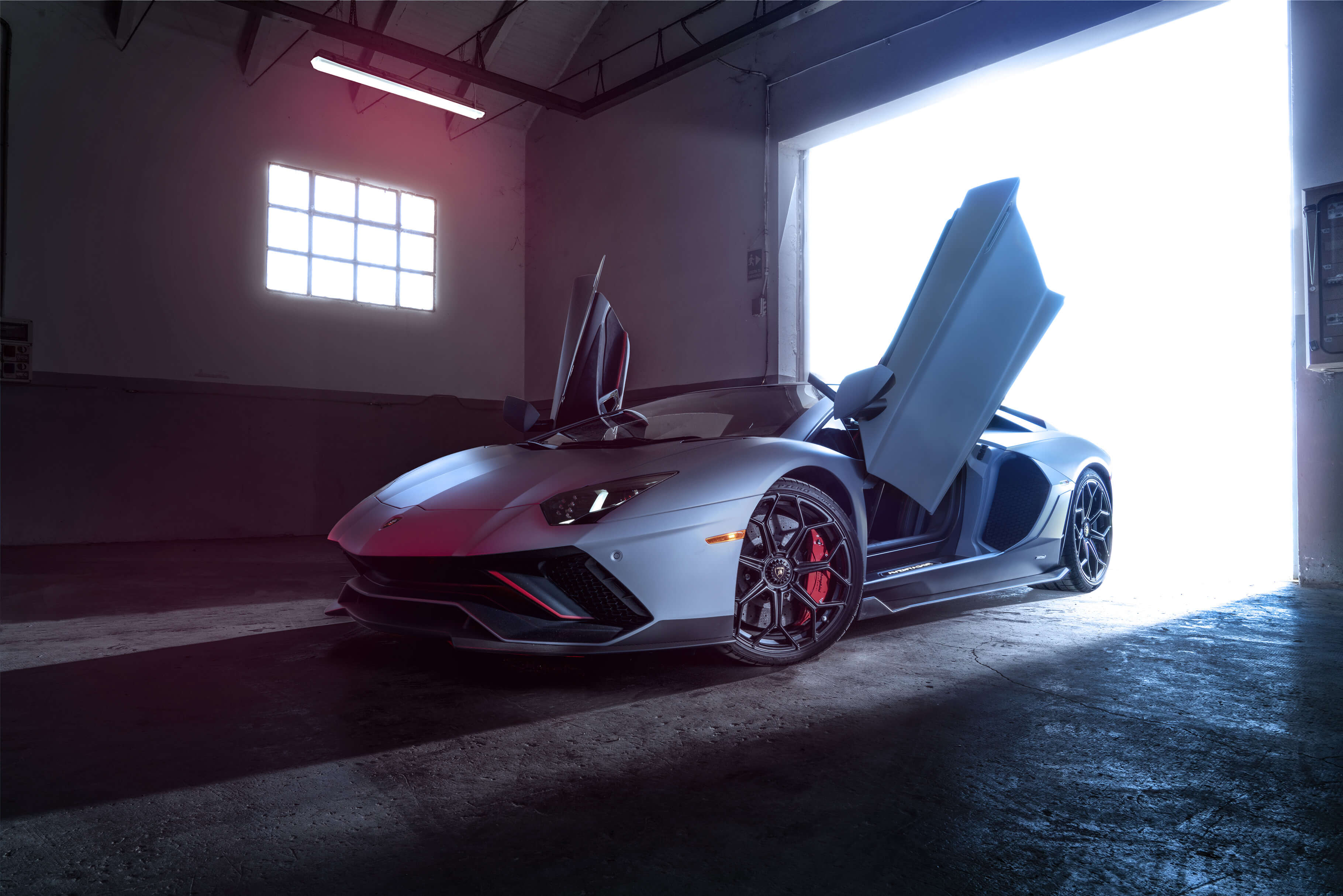 Angled side view of a Lamborghini Aventador LP 780-4 Ultimae filmed on track, captured from a dynamic driving video