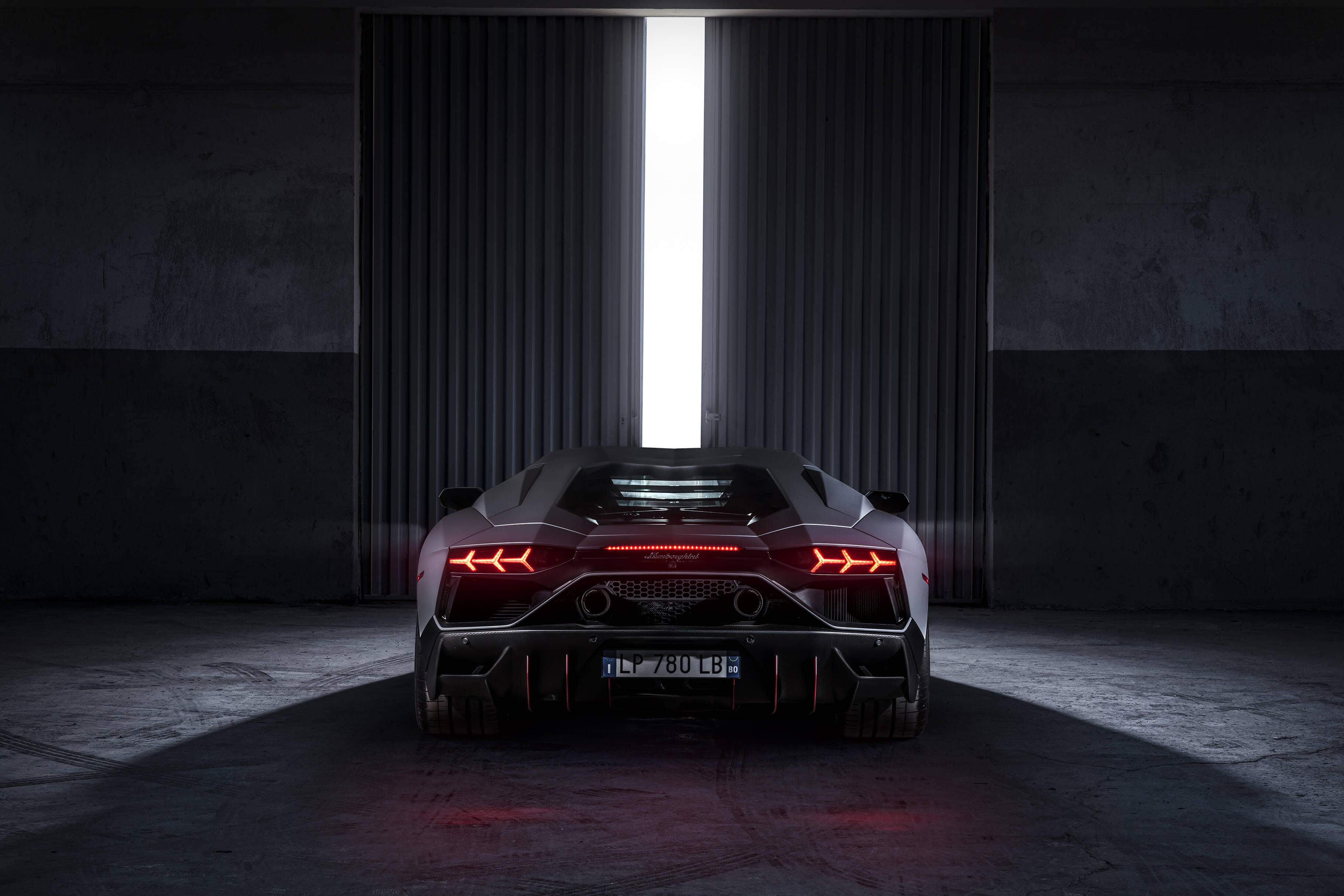 Angled side view of a Lamborghini Aventador LP 780-4 Ultimae filmed on track, captured from a dynamic driving video