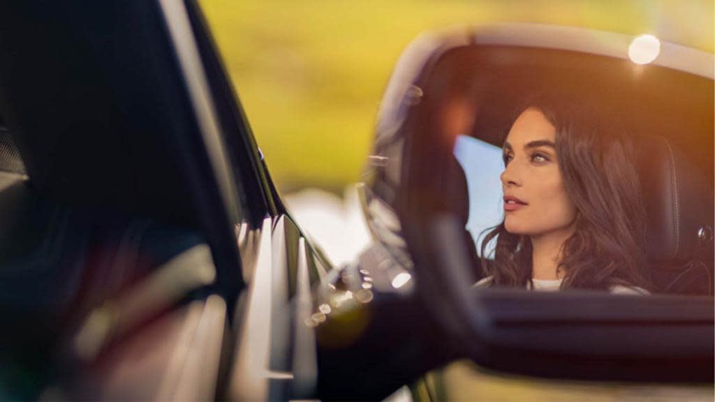 Woman driving a Bentley