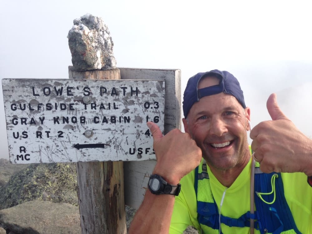 Doug Stoked at the Summit Sign