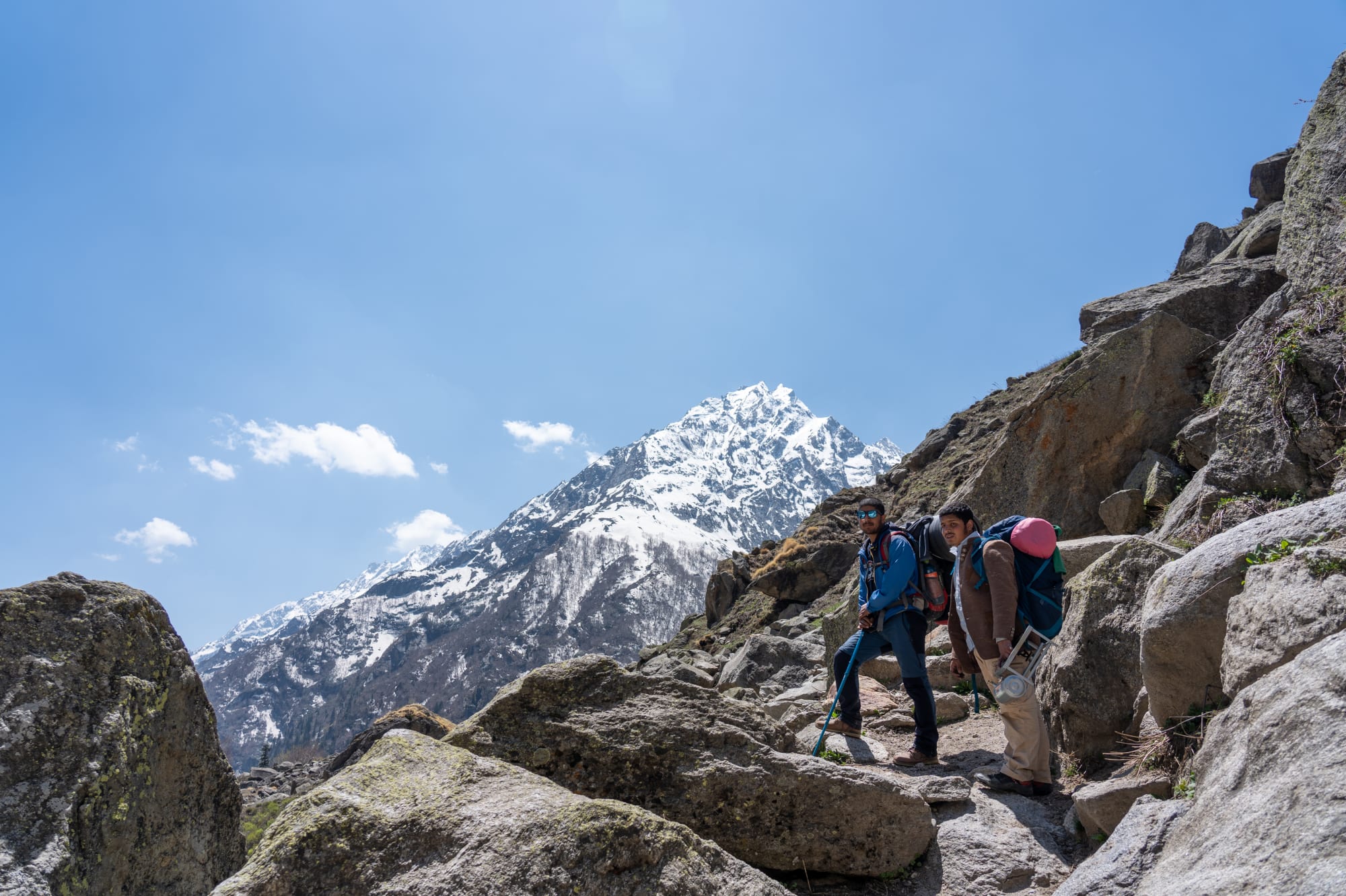 2 people on a path with an beatuiful mountain in the background