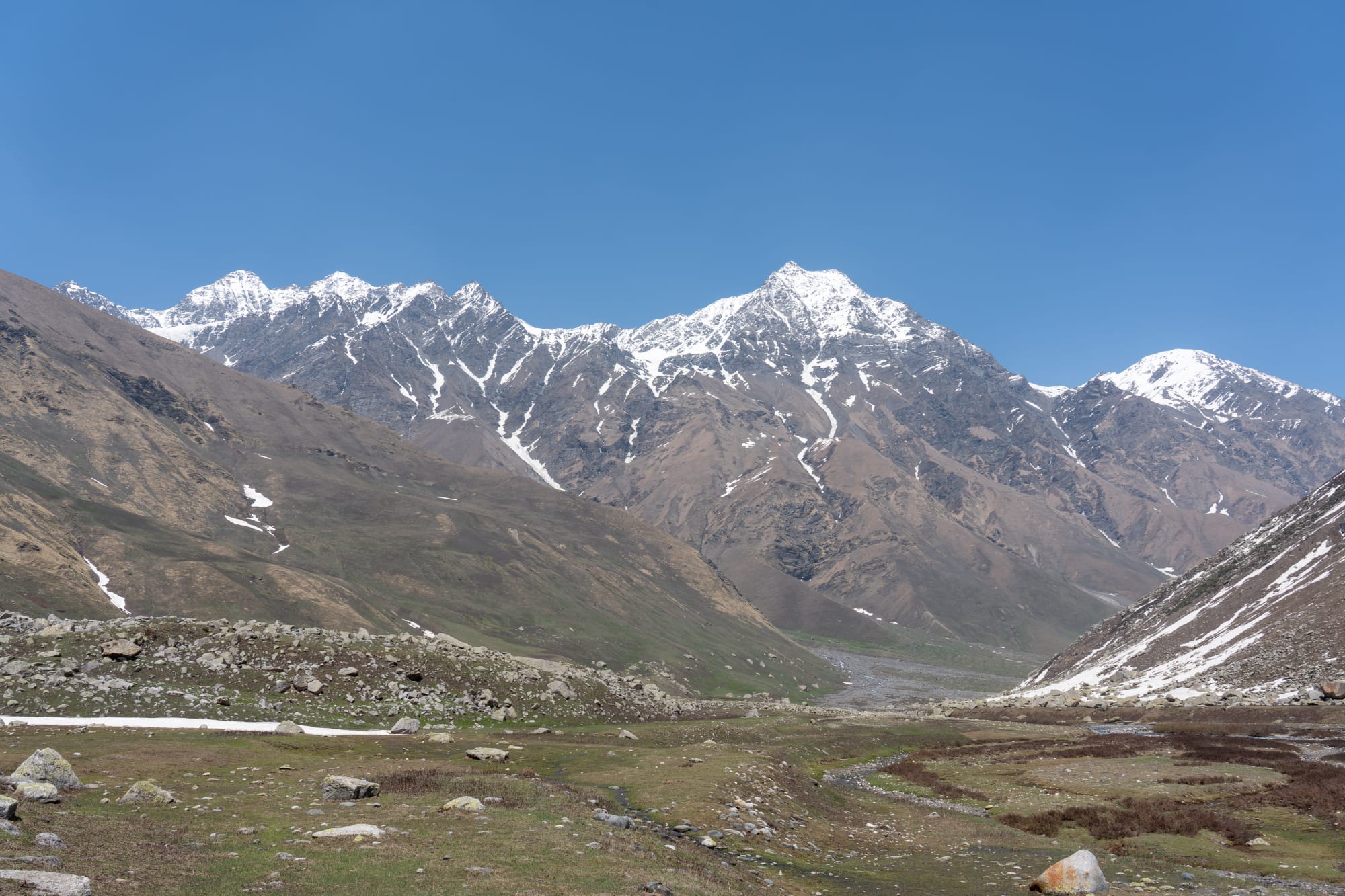 meadows of Bhaba valley with mountains in the background