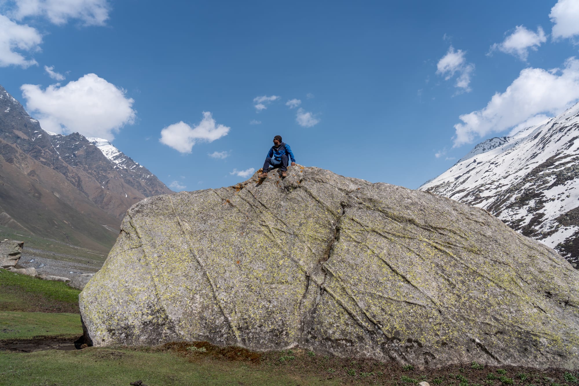 a person on a huge rock at Kara lake in Bhaba valley